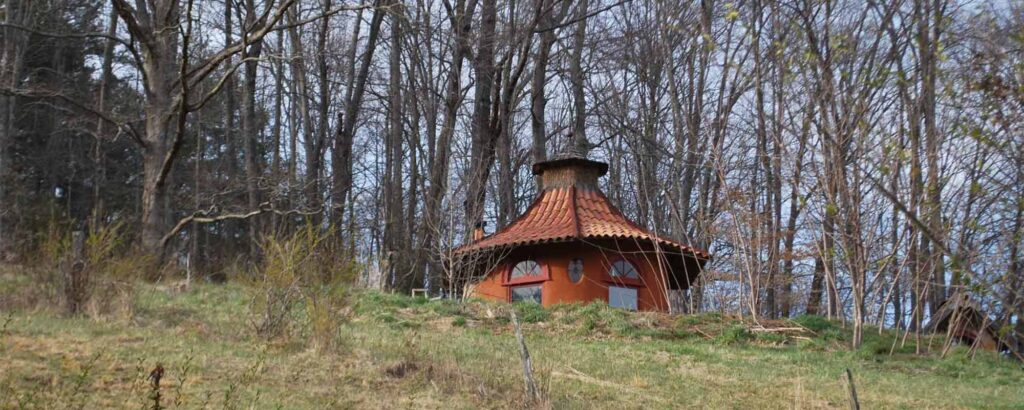 round natural building with curved roof adobe with plaster