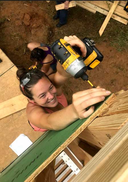 birds eye view of a woman driving a screw with an impact driver