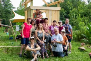 group of women in front of a child's play structure they build in a carpentry class