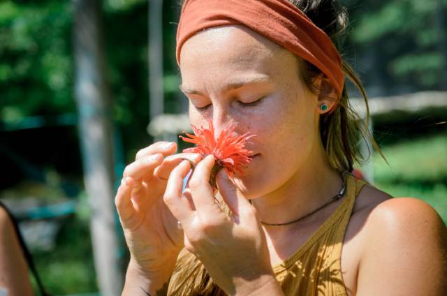 Woman smelling a wild monarda flower