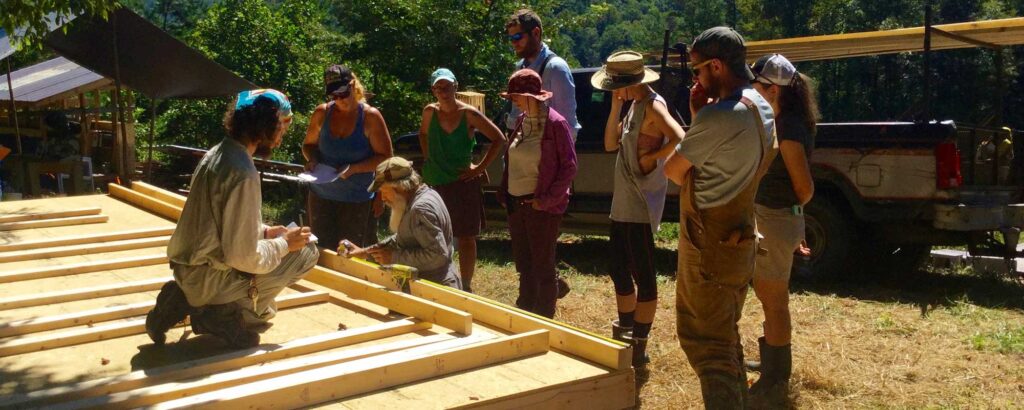 group of people building a tiny house