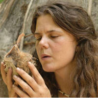 rewilding woman making friction fire