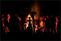 people around a fire at an earthskills gathering