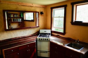 Yellow DIY paint on kitchen walls with natural wood counter tops