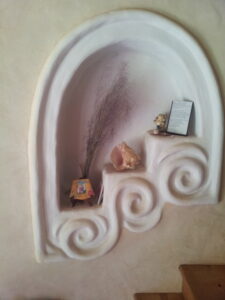 hand sculpted nicho in cobb wall painted with natural diy paint