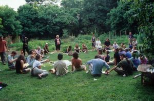 Group of people sitting in a circle forming an intentional community