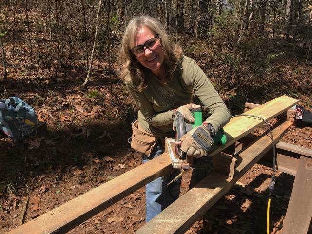 female using a circular saw in women's carpentry class