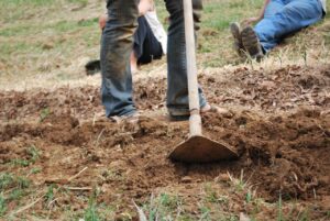 closeup of hoe digging into soil