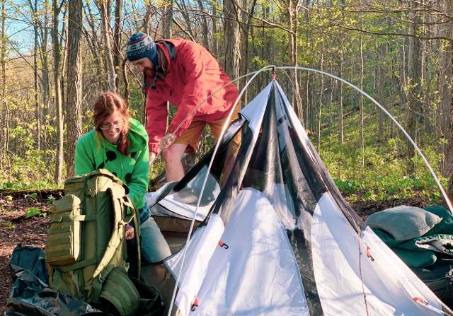 man and woman camping in cold weather