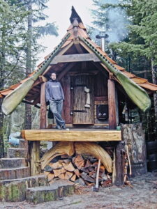 beautiful natural artistic small tiny house with man on porch