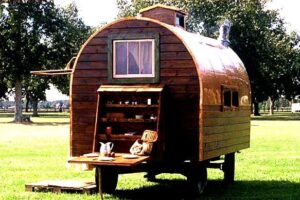 tiny arched hand built fishing cabin on wheels