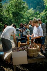 students in a Permaculture Design Course pressing apple cider