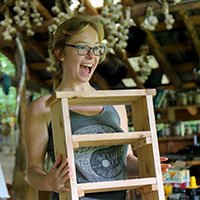 woman using a speed square to do carpentry