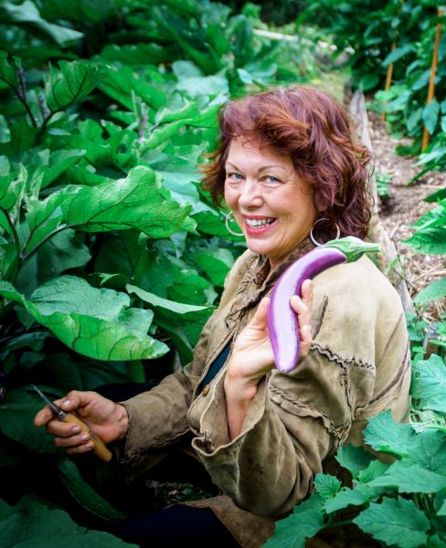 woman in garden with eggplant