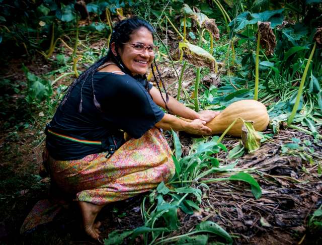 woman harvesting winter squash