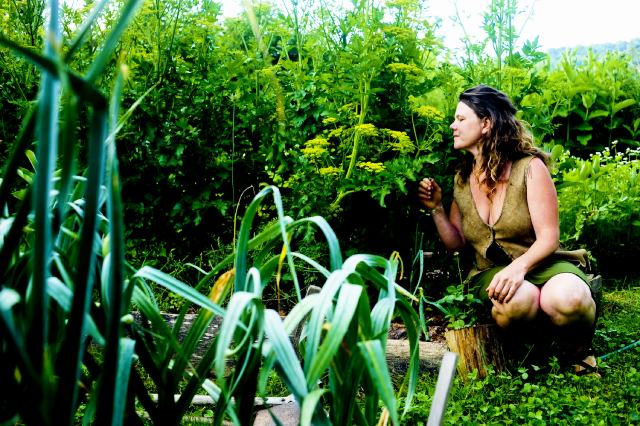 Woman smelling a plant