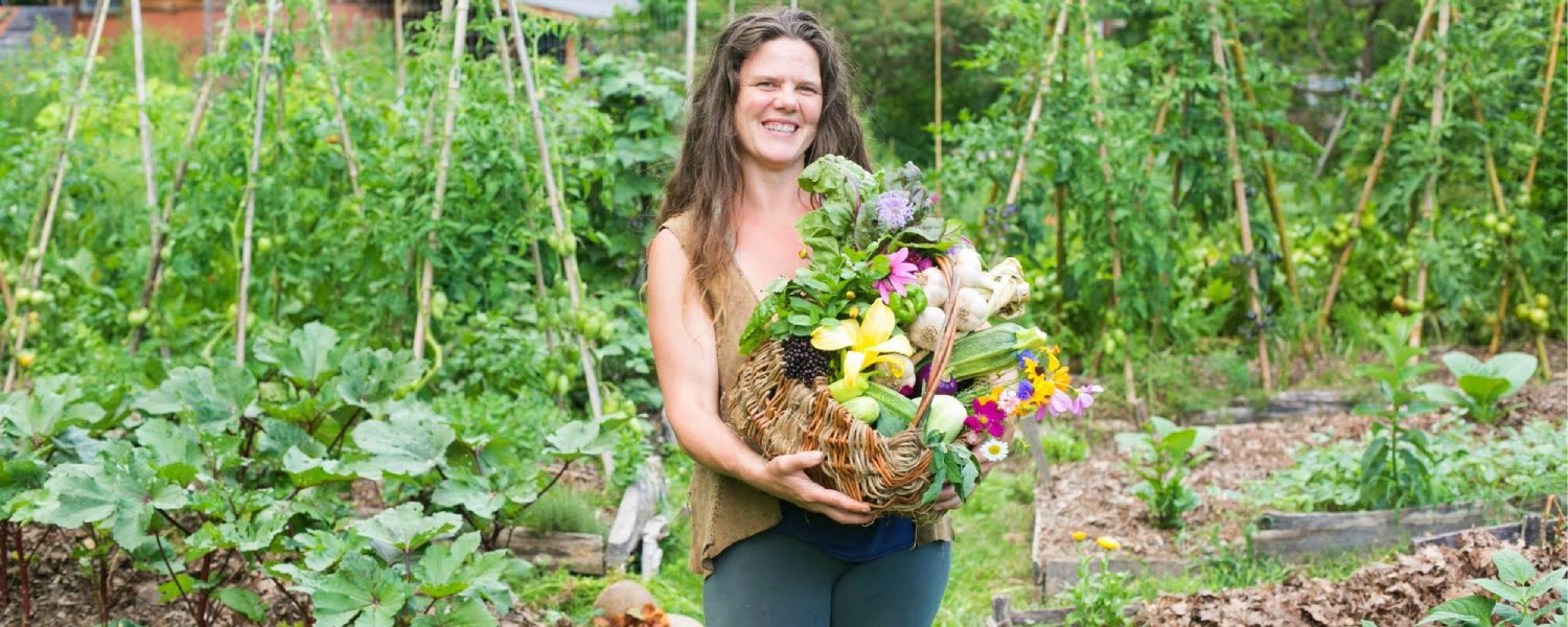 Woman holding a basket of vegetables grown in a garden