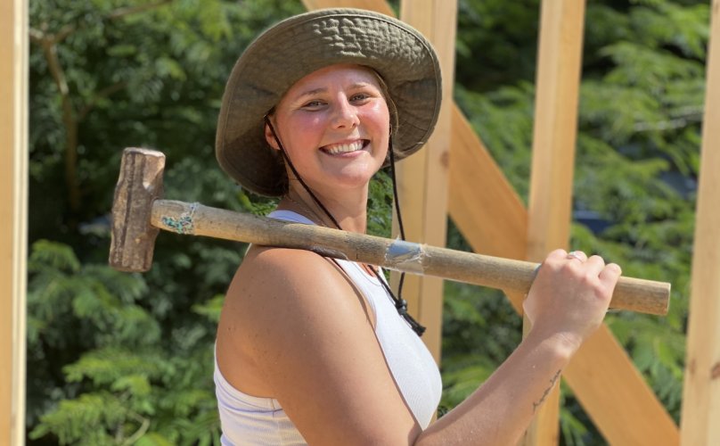 tiny house class student with sledgehammer