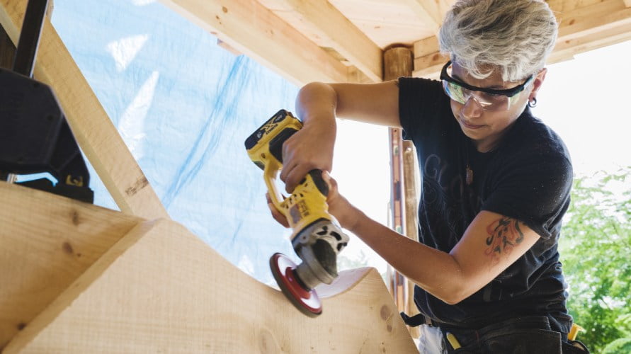 tiny house class student using angle grinder