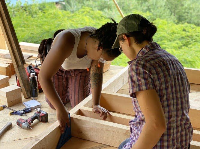 tiny house class students using speed square