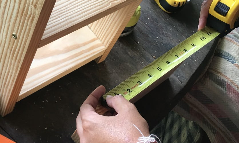 using a tape measure during women's carpentry class