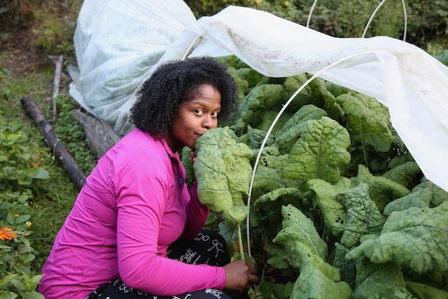 woman with giant kale leaf 