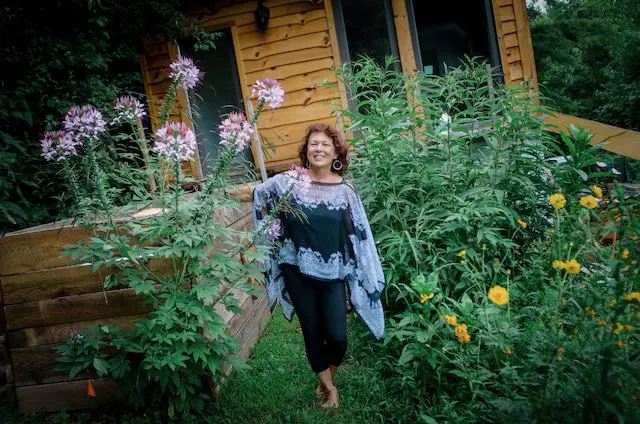 woman in a dress in her flower garden
