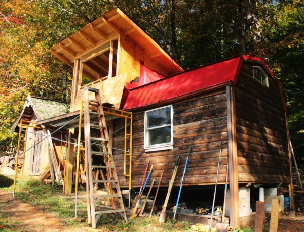 partially built tiny house and tools for building