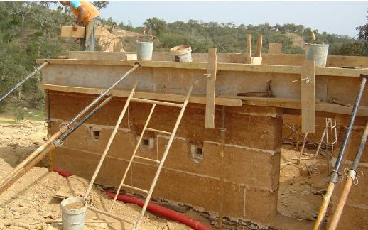 Rammed earth wall under construction