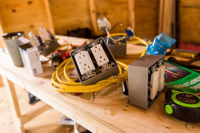Electrical box sits on a table during tiny house workshop
