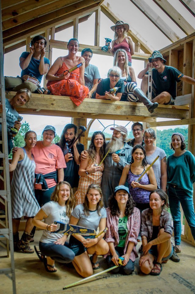 Students and instructors pose inside tiny house during workshop