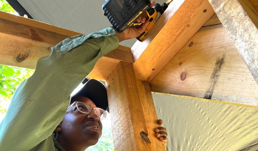 Woman uses drill during advanced women's carpentry course
