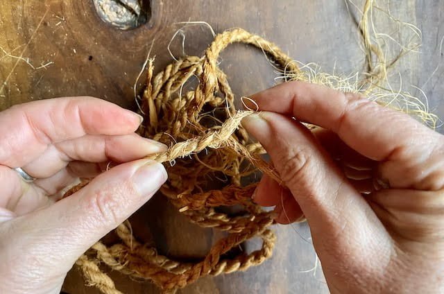 Woman's hands demonstrate how to make cordage