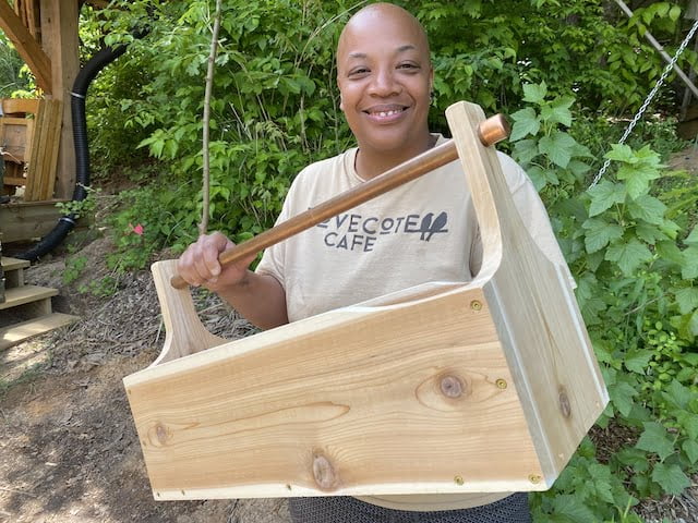 Student shows off toolbox built during women's basic carpentry course