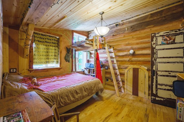 Bedroom in a log cabin not so tiny house