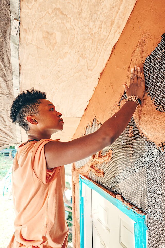 Student participates in natural building portion of tiny house class
