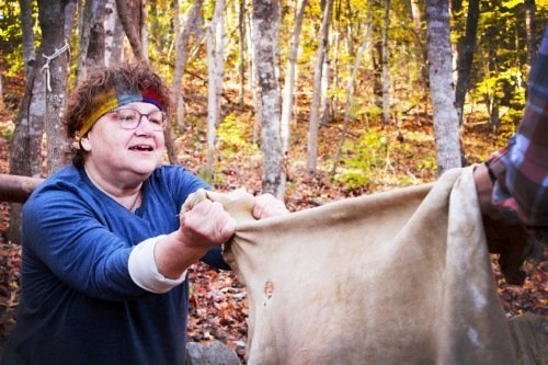 woman softening deer hide during brain tanning