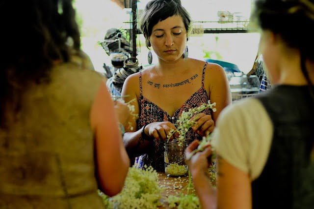 Woman prepares herbal medicine in an herbal medicine class in Asheville, NC