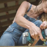 Woman uses drill to build tiny house