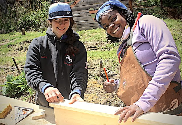 Student and instructor pose during women's basic carpentry course
