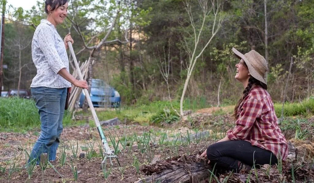 Two women participate in holistic gardening
