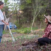 Two women participate in holistic gardening