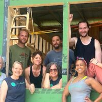 Students pose in front of tiny house during Tiny House Workshop