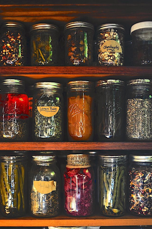 Jars of shelf pickles and herbs