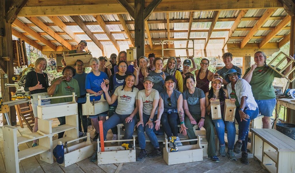 Students posing with projects during Women's Basic Carpentry Class