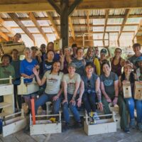 Students posing with projects during Women's Basic Carpentry Class