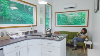 tiny house kitchen and living room design with lots of windows