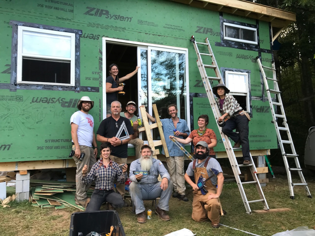 students in front of a tiny house during a tiny house building workshop