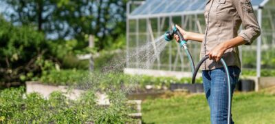 watering a garden with a water wand