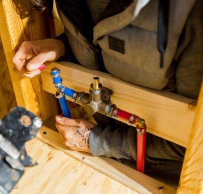Apprentice doing plumbing during building apprenticeship